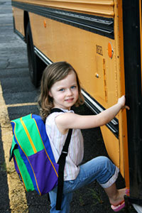 Girl getting on school bus